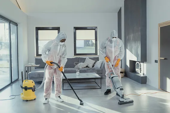 Two Orifilwe workers vacuuming the floor